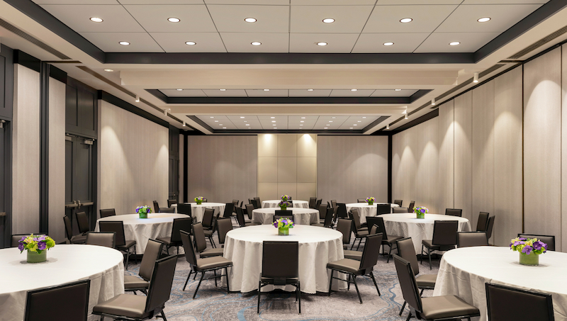 Banquet-style event space at Thompson Central Park Hotel NYC with round tables and modern design. Ella