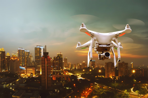 Rooftop venues nyc Small white drone flying over the city