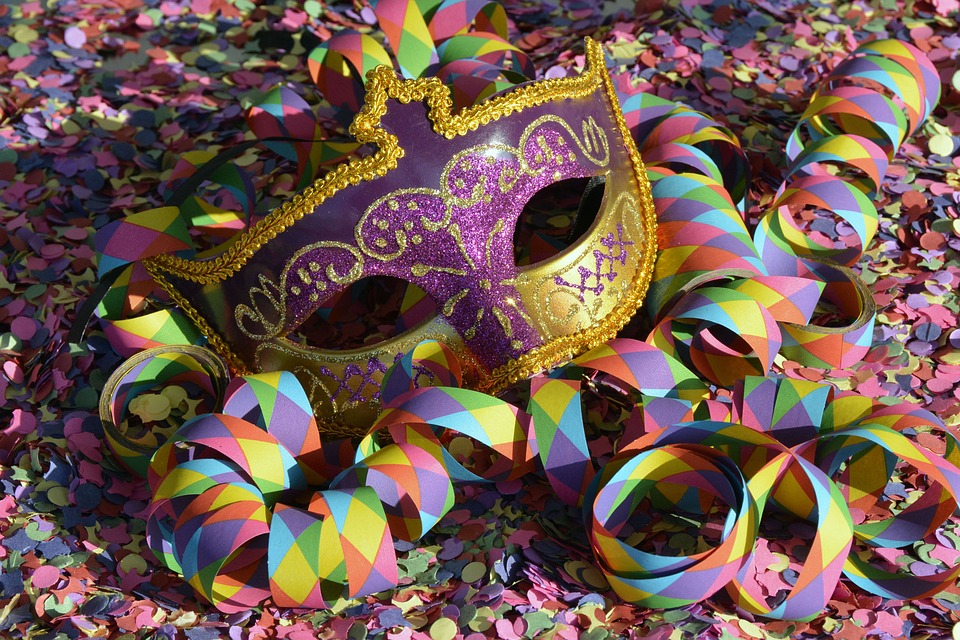 A Mardi Gras mask in rainbow confetti